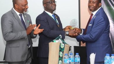 Mr Emem Bob (L) applauds as the President of CITN, Mr Samuel Agbeluyi, presents an award to Mr Okon Okon