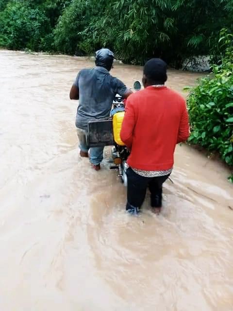 How collapsed bridge blocks children's path to high school in Ibiono Ibom community 4 • A commercial motorcycle rider & a passenger crossing through the river at Aka Ikot Udo Eno village.