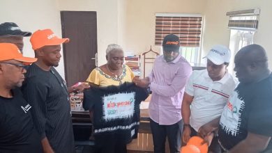 • Mrs. Essien receiving E’Ekpede branded materials from the group 